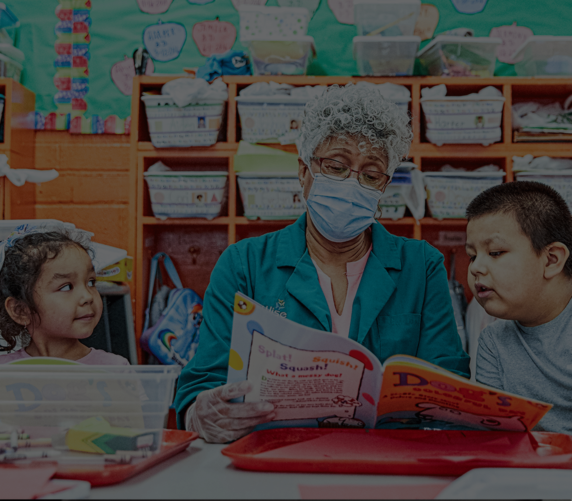 United Way is committed to diversity, equity and inclusion. This image shows an older woman reading to two children.